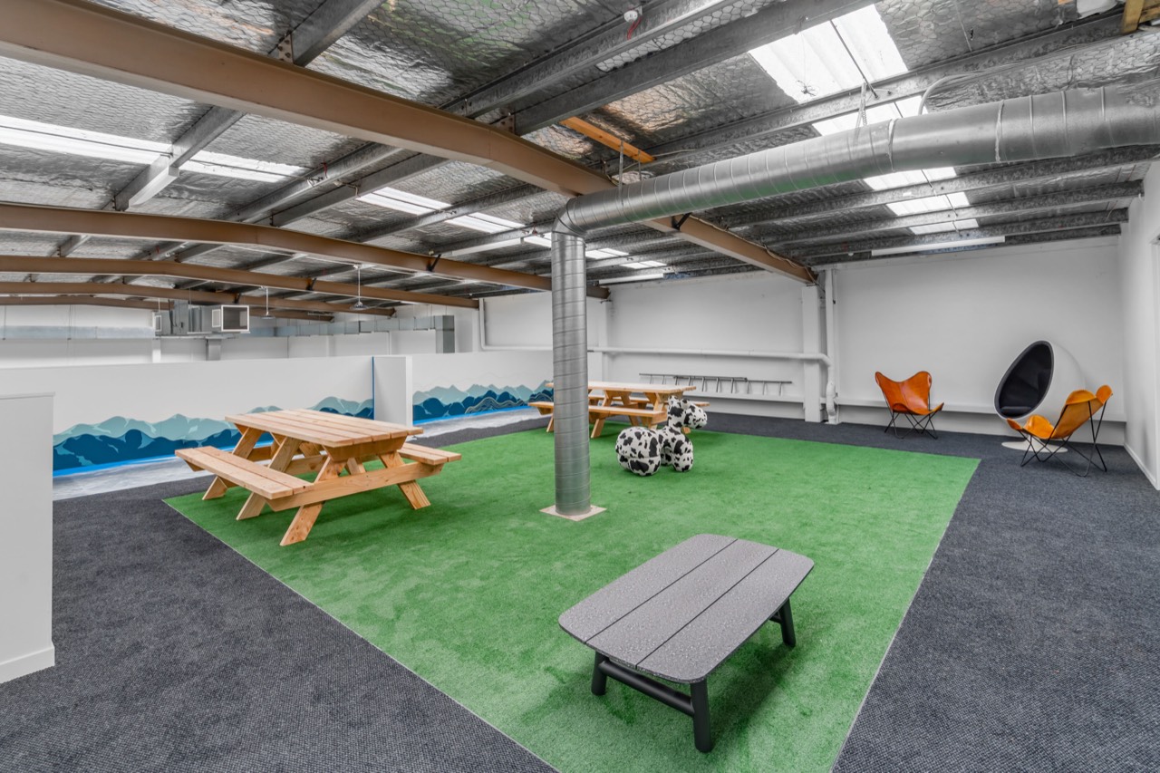 Artificial grass, picnic tables and seating under the skylights