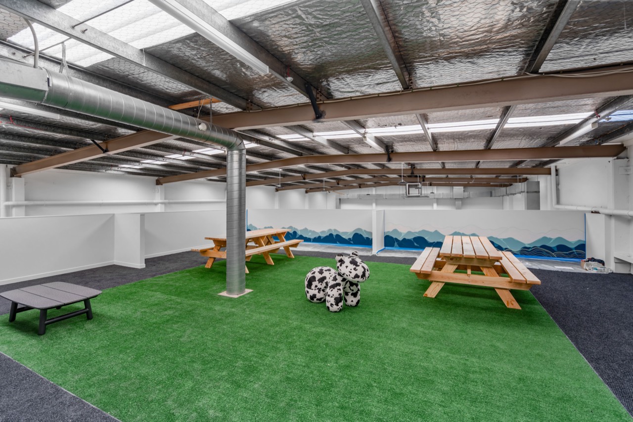 Picnic tables on artificial grass in the indoor park