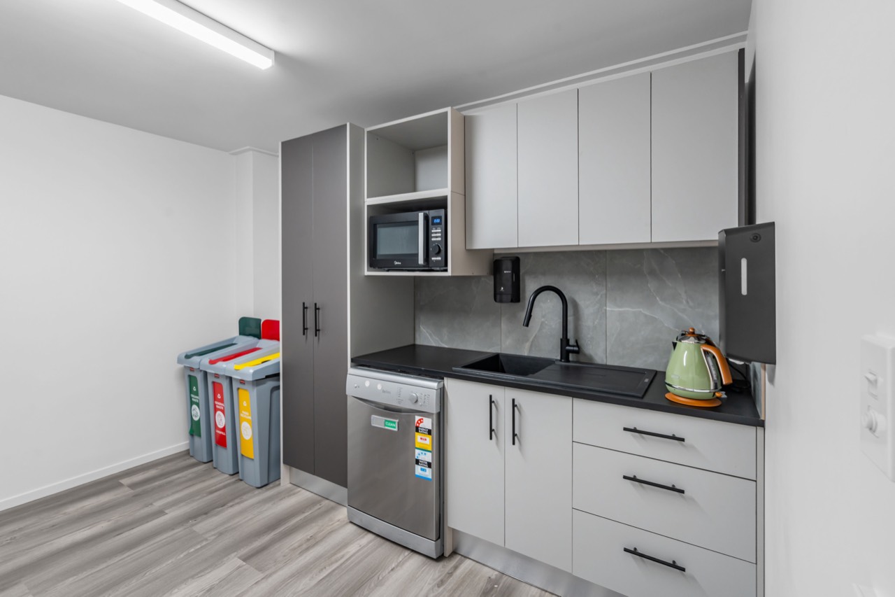 The shared kitchen, with dishwasher, microwave and recycling bins